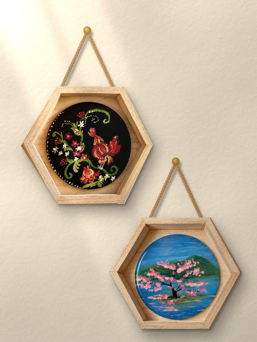 The Folk Rooster and Cherry Blossom Serenity pieces hanging from rope hangers